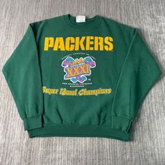 a green sweatshirt with the words packers on it