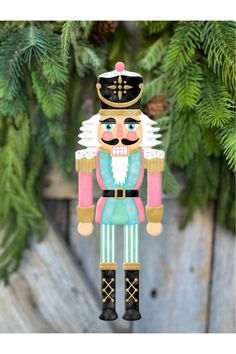 a nutcracker ornament hanging from a christmas tree