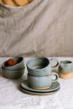 three cups and saucers sitting on a table