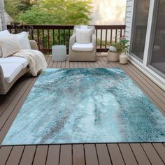 a blue area rug sitting on top of a wooden deck