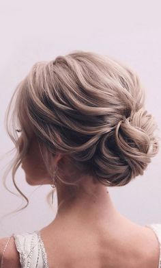 a woman with blonde hair in a low bun