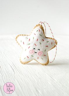 a white star ornament with sprinkles on it's side