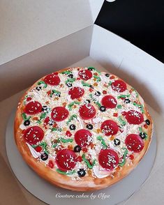 a pizza with pepperoni and olives in a box