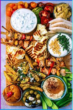 a platter with grilled chicken, veggies and dips