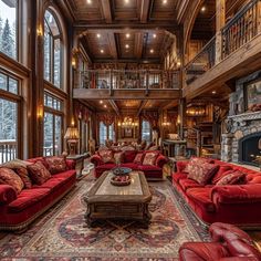 a living room filled with red couches and lots of windows