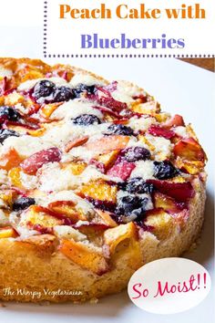 a cake with blueberries and other toppings sitting on top of a white plate