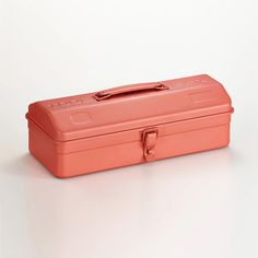 an orange lunch box sitting on top of a white table