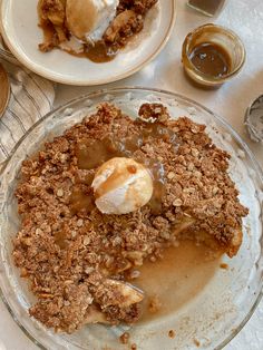 an apple crisp pie with ice cream and caramel sauce on the top is ready to be eaten