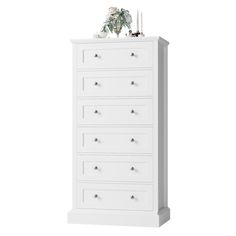 a white chest of drawers with flowers on top and candles in the bottom, against a white background