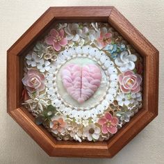 a wooden box with flowers in it and a heart shaped decoration on the inside wall