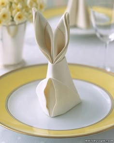 an origami rabbit sitting on top of a white plate