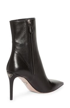 "Find PRADA Pointed Toe Boot on Editorialist. Instantly elevate any ensemble with this sleek and polished boot crafted in Italy from lambskin leather with a seamless front that leads to a pointy toe. The label's iconic triangle-logo hardware is inlaid at the top of the stiletto heel for a signature touch. 3 3/4\" (95mm) heel (size 38.5) 6\" shaft Side zip closure Leather upper, lining and sole Made in Italy Women's Designer Shoes" Pointed Toe Boots, Triangle Logo, Footwear Design Women, Lambskin Leather, Stiletto Heel, Side Zip, Designer Shoes, Black Boots, Designing Women