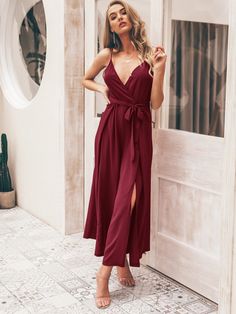 Introducing our fashionable Split Thigh Wide Leg Belted Cami Jumpsuit, the perfect choice for a chic and stylish look. This jumpsuit features a flattering spaghetti strap neckline and a high waistline, creating a sleek and sophisticated silhouette. The wide-leg design with a split thigh adds a touch of glamour and sexiness, while the wrap and pleated detailing adds texture and interest. The belt helps to cinch in the waist and create a more defined shape, adding a touch of elegance and sophistication. Specifications: Details: Belted, Wrap, Pleated, Zipper, Split Thigh Neckline: Spaghetti Strap Fit Type: Regular Fit Sleeve Length: Sleeveless Waist Line: High Waist Fabric: Slight Stretch Material: Fabric Composition: 100% Polyester Care Instructions: Machine wash or professional dry clean Pr Burgundy Jumpsuit, Comfy Jumpsuits, Boho Jumpsuit, Cami Jumpsuit, Leg Belt, Jumpsuit Online, Wedding Looks, Look Chic, Jumpsuits For Women