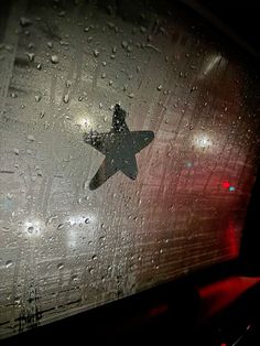 an airplane is seen through the rain covered window