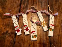 some christmas decorations are hanging on a wooden table