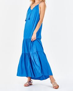 Strap halter maxi dress with side vents, cinching neck ties, deep back keyhole & armhole opening, tiered skirt. Simplicity in finest! Timeless exhibition of grace & serenity! Solid color woven on relaxed fit.Body length from HPS: 51", Sleeve length: N/A, Bust: 43" (Size Small) 100% TENCEL Machine wash cold, Line dry Imported Beach Maxi Dress With Tiered Skirt, Bohemian Tiered Maxi Dress With Tie Back, Blue Tiered Maxi Dress For Vacation, Breezy Blue Dress With Tie Back, Flowy Blue Tiered Maxi Dress, Blue Backless Maxi Dress With Tie Back, Blue Tiered Skirt Maxi Dress For Summer, Summer Tiered Maxi Dress With Tie Back, Bohemian Tiered Maxi Dress With Tie Straps