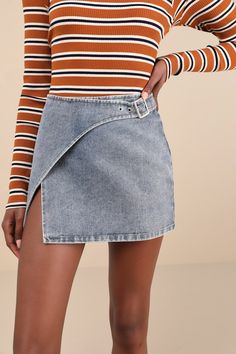 Grab your favorite top and the Lulus Trendsetting Cuteness Medium Wash Belted Wrap Denim Mini Skirt and you'll have an adorable OOTD! Sturdy cotton denim, with a grey-toned, faded effect throughout, shapes this retro-inspired skirt that has a high waist and a wrap-style silhouette that secures with an adjustable belt at the waist. Overlapping silhouette continues down to a mini hem. Silver hardware. Fit: This garment runs small - please size up. Length: Above mid-thigh. Size medium measures 14.5 High Waist Medium Wash Cotton Skort, Short Denim Blue Cotton Mini Skirt, Denim Blue Cotton Mini Skort, Trendy Denim Blue Cotton Skort, Medium Wash Cotton Mini Denim Skirt, Medium Wash Mini Cotton Skort, Chic Medium Wash Cotton Mini Skirt, Denim Blue Cotton Cutoff Mini Skirt, Denim Blue Cotton Skort, Short Length