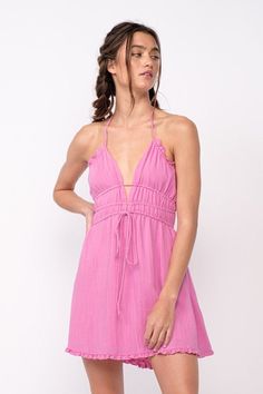 We're dreaming of a beautiful sunny day, and it starts with the Kristen Pink Halter Mini Dress! A cutout tie bodice with a plunging V-neckline meets a strappy, open back and an elastic waistband. The attached mini-skirt has an elastic waist. DETAILS & CARE 80% Rayon, 20% Polyester/LINING: Polyester. Hand wash cold or dry clean. Imported. V-neck Tie Back Sundress For Day Out, Spring V-neck Halter Dress With Crisscross Straps, Chic V-neck Beach Dress For Summer Outings, V-neck Tie Back Dress For Beach Season, Summer V-neck Dress With Knotted Straps, Spring V-neck Sundress Halter Dress, Flirty V-neck Sundress For Beach, Summer V-neck Dress With Elastic Back, Chic V-neck Sundress With Crisscross Straps