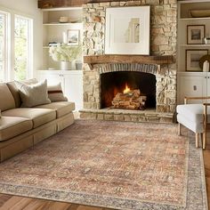 a living room filled with furniture and a fire place in the middle of a room