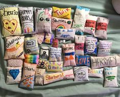 many different types of pillows are arranged on a bed with the words love written on them