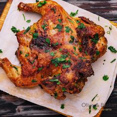 a cooked chicken on a cutting board with parsley