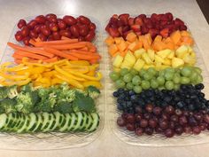 two plastic trays filled with different types of fruits and vegetables next to each other