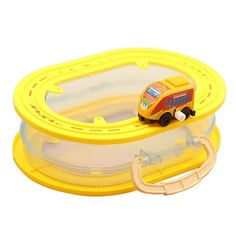 a toy bus is sitting on top of a yellow plastic container with an orange handle