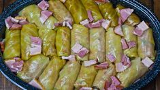 some food that is sitting in a pan on a wooden table and ready to be eaten