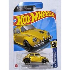 a yellow volkswagen beetle toy car on a white carded package with the words hot wheels