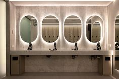 a row of sinks with mirrors above them