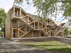 two people are walking in front of a wooden building