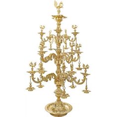 a gold colored chandelier with many lights on it's sides and an elaborately decorated base