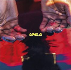 two hands holding the word umla in front of a red and blue background with yellow letters