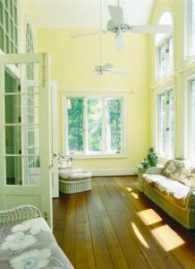 a living room filled with furniture and lots of windows on top of it's walls