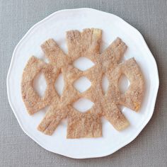 a white plate topped with crackers on top of a table