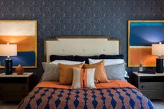 a bedroom with blue and orange decor on the walls, two nightstands and a bed