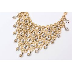 This is part of Chairish’s Costume Jewelry assortment.  This wonderful french bib geometric necklace has been attributed to Paco Rabanne, but is not signed. The inter-connecting, geometric brass links are with with fine precision and the faceted crystals are Swarovski in gray to radiant clear glass. There are 16 large crystals hanging and many smaller ones interspersed on the bib part. Even the clasp is a crystal. This necklace is adjustable as to how high or low you want to wear this around the Elegant Metal Bib Necklace With Chain, Elegant Metal Bib Necklace With Chain Detail, Bronze Metal Jewelry For Evening, Metal Chain Link Evening Jewelry, Metal Chain Link Jewelry For Evening, Evening Metal Chain Link Jewelry, Elegant Gold Bib Necklace With Adjustable Chain, Elegant Chainmail Chain Link Jewelry, Gold Art Deco Necklaces For Party