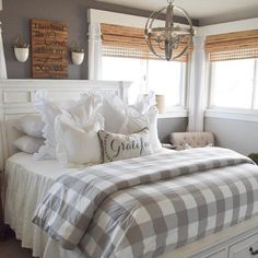 a bed with white sheets and pillows in a bedroom