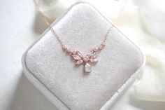 A dainty yet glamorous bridal necklace to add a touch of romance to your wedding! This rose gold necklace features an array of intricately cut cubic zirconia stones that shine brilliantly!Perfect for the bride or a bridal party !- Available in rose gold, yellow gold or rhodium finish- 17" (Length) - 1/16" (Width)- 3/4" (Drop) This is an original design by © Treasures by Agnes Delicate Rose Gold Diamond Necklace For Wedding, Rose Gold Cubic Zirconia Necklace With Sparkling Stones, Elegant Cubic Zirconia Bridal Necklace For Bridesmaid, Dazzling Rose Gold Diamond Necklace For Weddings, Rose Gold Cubic Zirconia Bridal Necklace For Anniversary, Rose Gold Wedding Necklaces With Diamond Accents, Rose Gold Wedding Necklace With Diamond Accents, Rose Gold Diamond Accent Wedding Necklace, Wedding Rose Gold Necklace With Diamond Accents