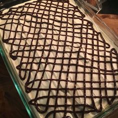 a glass baking dish filled with chocolate frosting