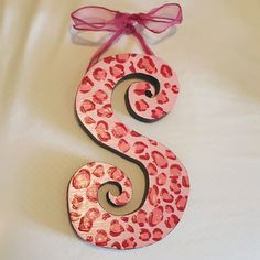 the letter s is decorated with pink and red leopard print