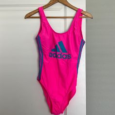 Adidas Swimsuit Brand New Neon Pink And Blue. Never Worn, Please Make An Offer! Pink Sleeveless Sports Bodysuit, Pink Sleeveless Bodysuit For Sports, Pink Sports Swimwear, Sporty Pink Bodysuit For Summer, Adidas Beachwear Swimwear For Poolside, Fitted Adidas Swimwear For Pool, Sporty Pink Fitted Swimwear, Pink Fitted Sporty Swimwear, Sporty Fitted Pink Swimwear