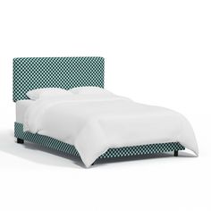 a bed with a checkered headboard and foot board in white, green and black