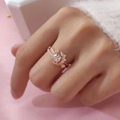 a woman's hand with a diamond ring on it