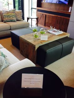 a living room filled with furniture and a flat screen tv mounted on the wall above it