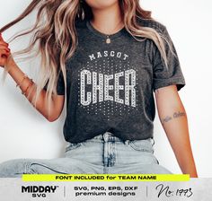 a woman sitting on the ground with her hair blowing in the wind and wearing a t - shirt that says ms scott cheer