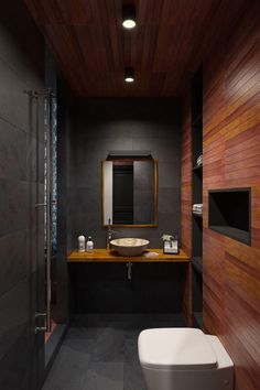 a modern bathroom with wood paneling and black walls