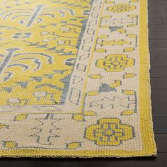 a yellow and gray rug on the floor