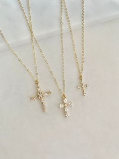 Stunning Pave Cubic Zirconia cross necklaces.  Take your pick. Gorgeous gift necklace, baptism or dedication gift.  Beautiful bridal necklaces too.   - Pendants - CZ + 14k gold plated brass - tarnish resistant - Chain + components - 14K Gold-filled  - Lobster Clasp - 14K Gold-filled   Cross #1 - 20mm x 27mm Cross #2 - 11mm x 16mm Cross #3 - 11mm x 14mm Listing is for one cross.  Choose from the pulldown menu. . . . . . . . . . . . . . . . . . . . . . . . . . . . . . . . . . .  Necklace arrives p Delicate Cross Jewelry For Wedding, Delicate Cross Necklaces For Weddings, Delicate Cross Necklace For Wedding, Cubic Zirconia Crucifix Necklace For Gift, Gold Cross Jewelry For Confirmation, Dainty Cross Pendant Jewelry For First Communion, Dainty Cross Pendant Necklace For Baptism, Elegant Cross Pendant For Confirmation, Dainty Gold Cross Necklace For Baptism