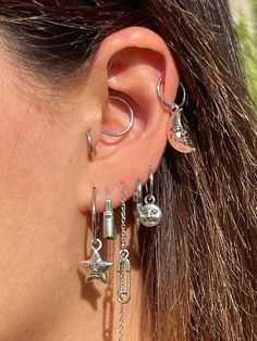 a close up of a person's ear with some piercings attached to it